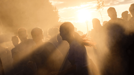 Menschen feiern in der Dämmerung © imago images/Christian Mang