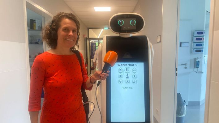 Julia Vismann neben dem Workerbot9 Care-Home Romy