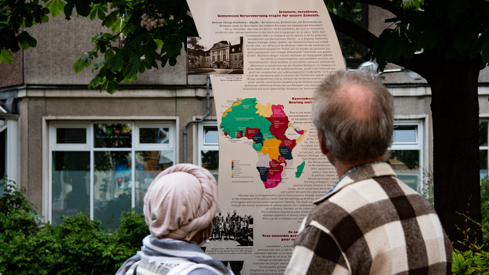 Berlin-Mitte: Eine Frau und ein Mann stehen vor der Gedenktafel zur Kongokonferenz